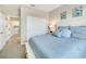 Comfortable bedroom featuring a bed with soft blue bedding, closet and ensuite access at 13823 Messina Loop # 204, Bradenton, FL 34211