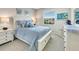 Cozy bedroom featuring a queen-size bed with blue bedding and light-colored walls at 13823 Messina Loop # 204, Bradenton, FL 34211