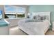 This bedroom features a waterfront view and a bright, cheerful design with modern furnishings at 13823 Messina Loop # 204, Bradenton, FL 34211