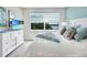 A beautifully staged bedroom with a waterfront view, ample natural light, and stylish, modern decor at 13823 Messina Loop # 204, Bradenton, FL 34211