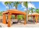 Cozy cabana with comfortable seating, perfect for relaxing by the pool in a lush, tropical setting at 13823 Messina Loop # 204, Bradenton, FL 34211