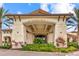 The clubhouse's entrance boasts stone columns, arched entryways, and meticulously manicured landscaping at 13823 Messina Loop # 204, Bradenton, FL 34211