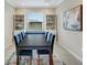 Stylish dining room with bookshelves and natural light at 13823 Messina Loop # 204, Bradenton, FL 34211