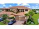 This exterior shot highlights the attached garages, landscaping, and Spanish tile roof at 13823 Messina Loop # 204, Bradenton, FL 34211