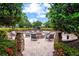 A cozy outdoor fire pit area surrounded by comfortable seating and lush landscaping at 13823 Messina Loop # 204, Bradenton, FL 34211