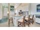 Bright kitchen featuring granite countertops, modern appliances, and barstool seating at 13823 Messina Loop # 204, Bradenton, FL 34211