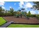 Safe and fun community playground with slide, climbing structures, and cushioned ground at 13823 Messina Loop # 204, Bradenton, FL 34211
