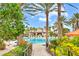 Lush landscaping surrounds the pool, creating a serene path leading to a luxurious poolside retreat at 13823 Messina Loop # 204, Bradenton, FL 34211