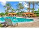 Inviting pool area with private cabanas and comfortable lounge chairs, ideal for a relaxing day in the sun at 13823 Messina Loop # 204, Bradenton, FL 34211