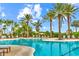 Inviting swimming pool surrounded by lush palm trees and lounge chairs, offering a relaxing outdoor oasis at 13823 Messina Loop # 204, Bradenton, FL 34211