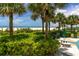 Picnic area by a beautifully landscaped beachside with palm trees and green shrubbery in the background at 1390 Gulf Blvd # Ph 2, Clearwater Beach, FL 33767