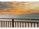 Balcony view overlooking a serene beach and ocean horizon at sunset at 1390 Gulf Blvd # Ph 2, Clearwater Beach, FL 33767