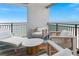 Comfortable balcony seating arrangement with stunning ocean views and a colorful rug at 1390 Gulf Blvd # Ph 2, Clearwater Beach, FL 33767