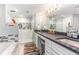 Well-lit bathroom featuring a glass-enclosed shower, double vanity, and stylish decor at 1390 Gulf Blvd # Ph 2, Clearwater Beach, FL 33767