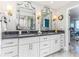 Elegant bathroom with dual sinks, marble countertops, and decorative mirrors creating a luxurious space at 1390 Gulf Blvd # Ph 2, Clearwater Beach, FL 33767