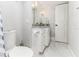 Bathroom featuring a toilet, a marble tiled floor, and a single sink vanity with modern lighting at 1390 Gulf Blvd # Ph 2, Clearwater Beach, FL 33767