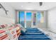Coastal bedroom with plush bedding, ocean view, and decorative oars, creating a serene retreat at 1390 Gulf Blvd # Ph 2, Clearwater Beach, FL 33767