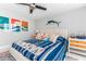 Bright bedroom featuring nautical decor, plush bedding, and a ceiling fan at 1390 Gulf Blvd # Ph 2, Clearwater Beach, FL 33767