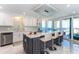 Island kitchen with breakfast bar seating offering views from the sliding glass door to the balcony at 1390 Gulf Blvd # Ph 2, Clearwater Beach, FL 33767