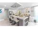 Well-lit kitchen with marble countertops, wine rack, island seating, and stainless appliances at 1390 Gulf Blvd # Ph 2, Clearwater Beach, FL 33767