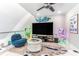 Comfortable loft area with large-screen TV, stylish seating, and unique blue wall decorations at 1390 Gulf Blvd # Ph 2, Clearwater Beach, FL 33767
