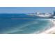 Beautiful ocean view from the beach with a pier and buildings in the distance on a clear, sunny day at 1390 Gulf Blvd # Ph 2, Clearwater Beach, FL 33767