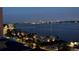 Water view of a waterfront home at dusk featuring city skyline lights at 1390 Gulf Blvd # Ph 2, Clearwater Beach, FL 33767