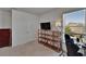 Bright bedroom featuring shelving, a window with blinds, and space for a desk at 14153 Arbor Pines Dr, Riverview, FL 33579