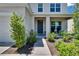 Inviting front entrance with manicured landscaping, covered porch, and neutral exterior color scheme at 14153 Arbor Pines Dr, Riverview, FL 33579