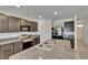 Modern kitchen featuring granite countertops, stainless steel appliances, and dark wood cabinets at 14153 Arbor Pines Dr, Riverview, FL 33579