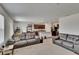 Open-concept living space featuring plush sofas, neutral carpet, and access to the modern kitchen at 14153 Arbor Pines Dr, Riverview, FL 33579