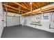 Spacious garage with painted floor, exposed rafters, and garage door at 1431 Kings Hwy, Clearwater, FL 33755