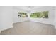 Sunlit living room featuring tile flooring and large windows at 1431 Kings Hwy, Clearwater, FL 33755