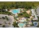 Aerial view of community amenities including pools, clubhouse, playground, parking, and green space at 16313 Bridgecrossing Dr, Lithia, FL 33547