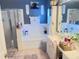 Well-lit bathroom with a soaking tub, walk-in shower, dual sinks, and modern fixtures at 16313 Bridgecrossing Dr, Lithia, FL 33547