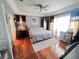 Serene primary bedroom with hardwood floors, a comfortable bed, and large windows for natural light at 16313 Bridgecrossing Dr, Lithia, FL 33547