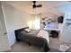 Comfortable bedroom with a desk, a bed, and ample lighting for studying and relaxation at 16313 Bridgecrossing Dr, Lithia, FL 33547