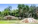 Welcoming FishHawk Ranch entrance featuring lush landscaping and a decorative stone monument at 16313 Bridgecrossing Dr, Lithia, FL 33547