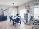 Inviting dining room with a large table, blue chairs, and a window seat perfect for Gathering gatherings at 16313 Bridgecrossing Dr, Lithia, FL 33547
