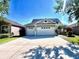 Charming single-story home with a three-car garage and a well-maintained lawn and landscape at 16313 Bridgecrossing Dr, Lithia, FL 33547
