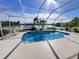 Screened-in pool area providing a relaxing view of the lake and natural landscape at 16313 Bridgecrossing Dr, Lithia, FL 33547