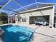 Covered lanai features an inground pool, patio area, and access to indoor living space at 16313 Bridgecrossing Dr, Lithia, FL 33547
