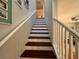 A nice staircase with carpet and wood leading to the second floor at 16313 Bridgecrossing Dr, Lithia, FL 33547