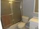 Bathroom featuring a bathtub with shower, white vanity, and neutral tiling at 1660 Caledonia Dr, Palm Harbor, FL 34684