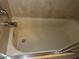 Close up on bathtub with tile walls and silver hardware at 1660 Caledonia Dr, Palm Harbor, FL 34684