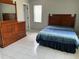 Bedroom with wooden dresser and bed, with window letting in natural light at 1660 Caledonia Dr, Palm Harbor, FL 34684