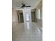 A bonus room featuring tile flooring, two closets, tongue and groove wall paneling, and a ceiling fan at 1660 Caledonia Dr, Palm Harbor, FL 34684