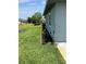 A home exterior featuring a manicured lawn and garden bed at 1660 Caledonia Dr, Palm Harbor, FL 34684