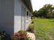 A home exterior featuring flowers and well-maintained landscaping at 1660 Caledonia Dr, Palm Harbor, FL 34684