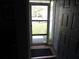 A home foyer looking out the front door to the front yard at 1660 Caledonia Dr, Palm Harbor, FL 34684